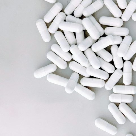 White supplement capsules