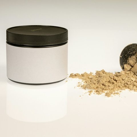 A jar of protein powder with a scoop